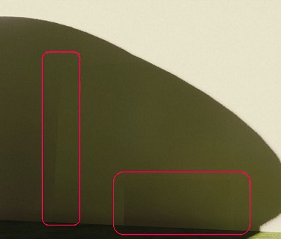 Two seams on a wall which show the sharp changes in lighting conditions between light and dark.