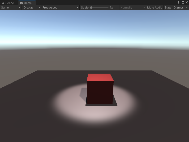 An image of the Game view, that displays a simple scene with a plane and a cube GameObject. The cube is lit by a spotlight from above.