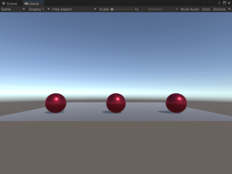 An image of the Game view. Three red spheres sit on a plane.