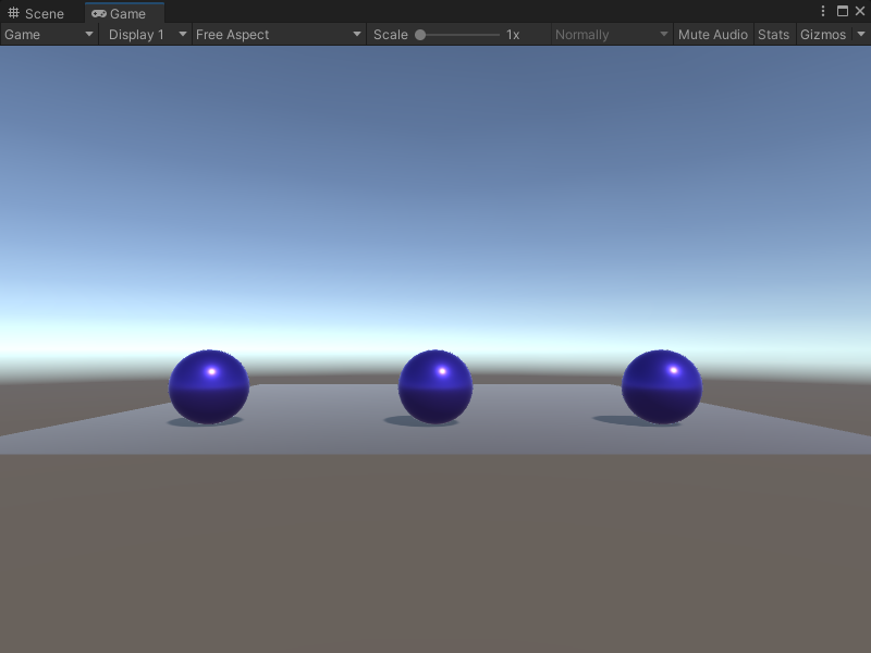 An image of the Game view. Three purple spheres sit on a plane.