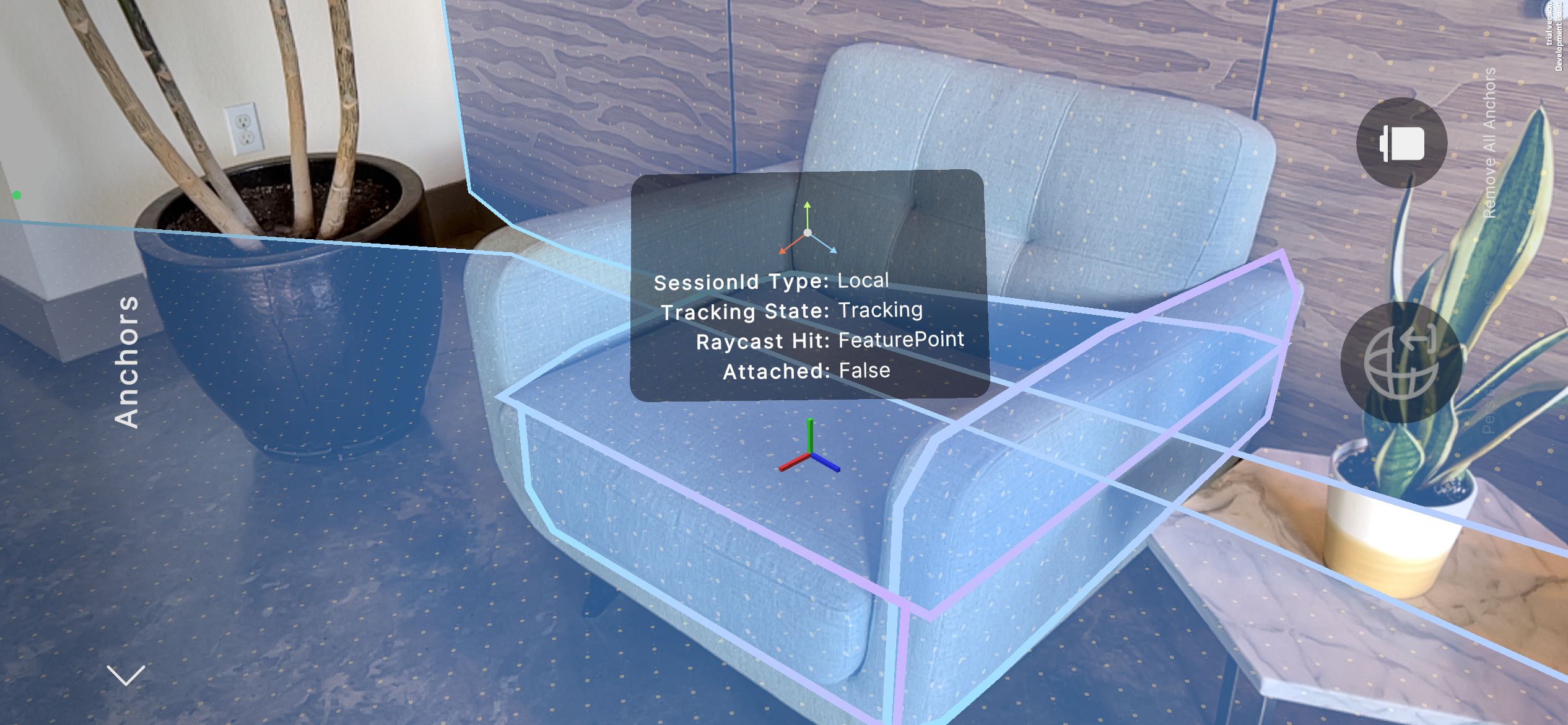 A screenshot from a mobile device shows an interior room with a chair. Translucent blue polygons indicate that planes have been detected on the floor, walls, and chair. The user has placed an anchor on the chair by tapping the screen.